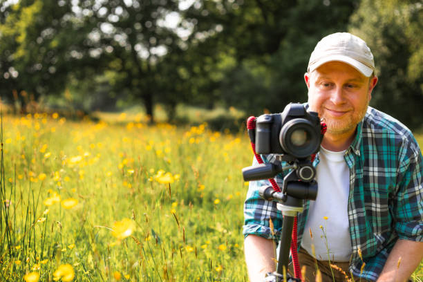 istock Happy photographer at work in nature 2153993466