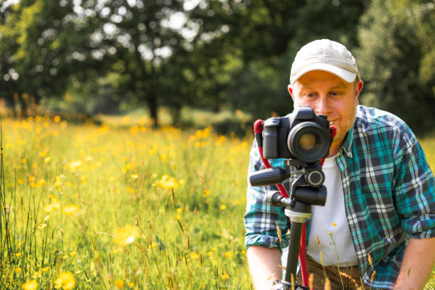 istock Happy photographer at work in nature 2153993487