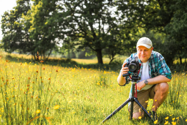 istock Happy photographer at work in nature 2153993525