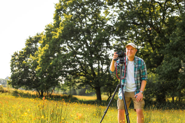 istock Happy photographer at work in nature 2153993555