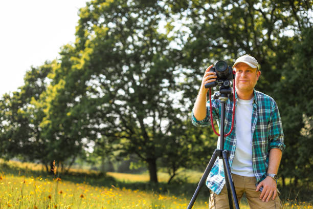 istock Happy photographer at work in nature 2153993579
