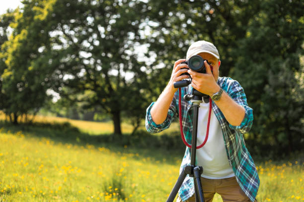 istock Happy photographer at work in nature 2153993621