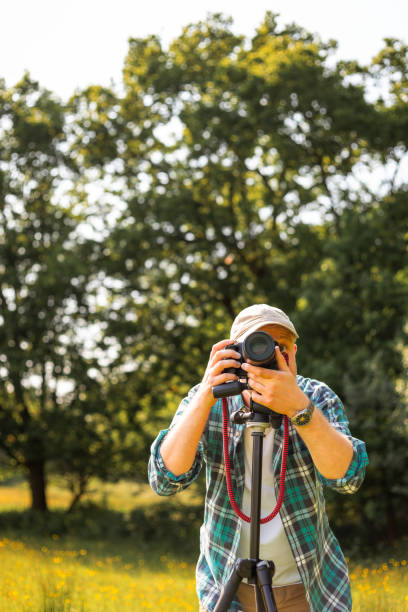 istock Happy photographer at work in nature 2153993653