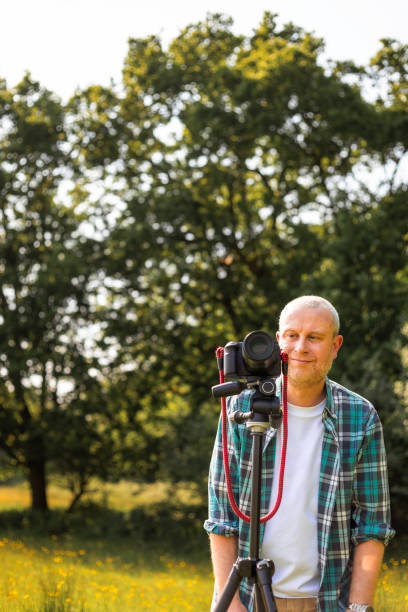 istock Happy photographer at work in nature 2153993658