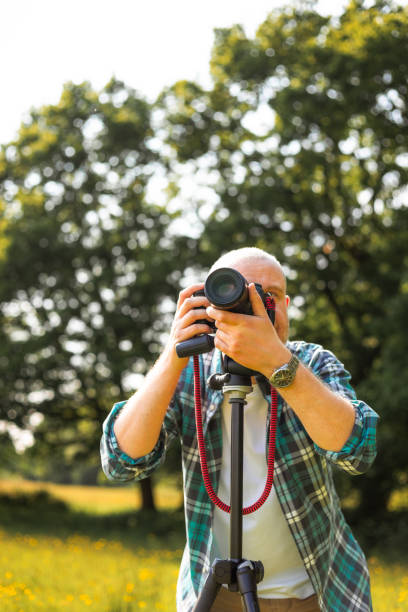 istock Happy photographer at work in nature 2153993659