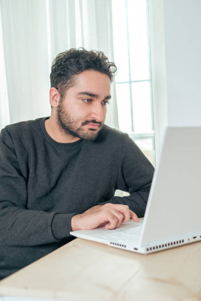 istock Focused Man Working on Laptop at Home 2153994775