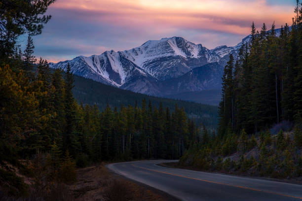 istock Sunrise Sky Glowing Over A Mountain Road In Banff 2153996703
