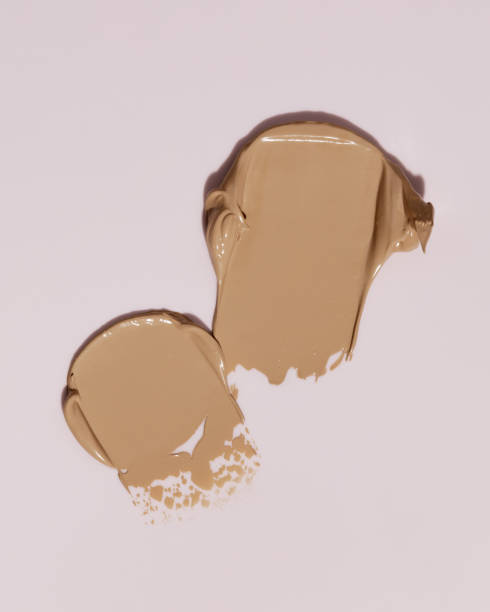 istock Makeup foundation, beige concealer swatch smudge smear on pink background. BB CC cream texture 2153997354