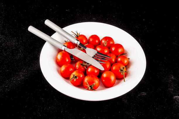 Five tomatoes shot directly from above on kitchen table in the morning