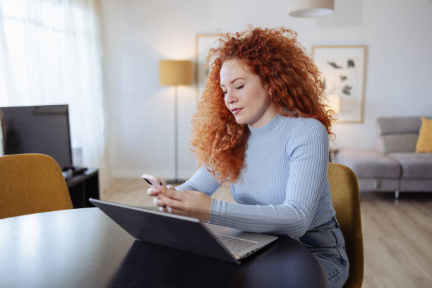 istock Young beautiful woman using wireless technology at home 2154001844
