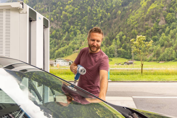 istock Man Preparing to Charge Electric Car 2154002916