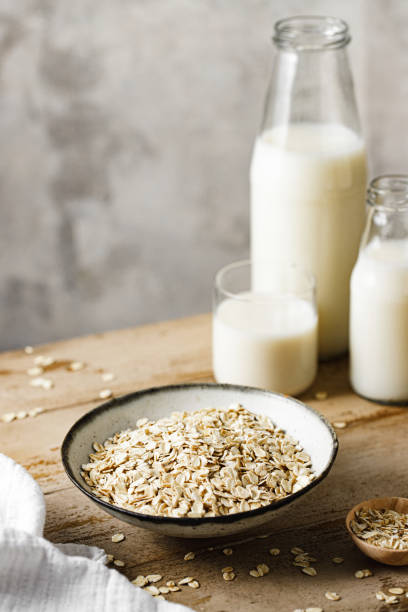 istock Oats in a bowl with oat milk bottles on table 2154003492