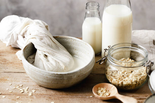 istock Squeezing the strain cloth to extract oat milk into a bowl 2154003516