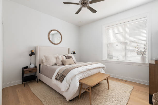 istock A cozy bedroom with wood flooring and neutral bedding. 2154004076