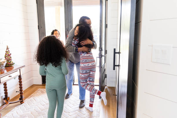 istock Unrecognizable sisters welcome their grandparents inside the house 2154007392