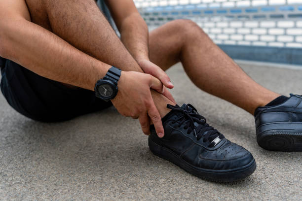 istock Man holding leg in pain on bridge 2154009888