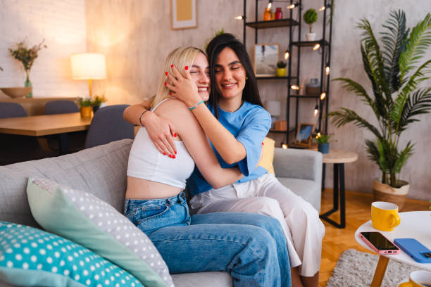 istock Two beautiful young women hugging each other 2154010176