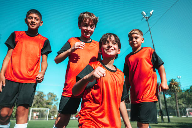 istock four soccer boys cheering after scoring a goal 2154010219