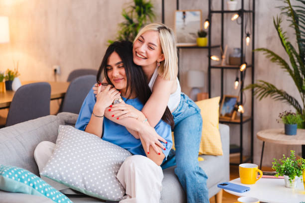 istock Two happy young women hugging each other at home 2154010829