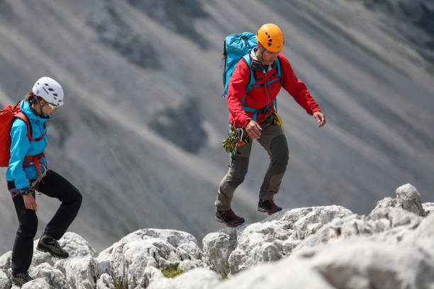 istock Two mountaineers walking on the edge 2154010916