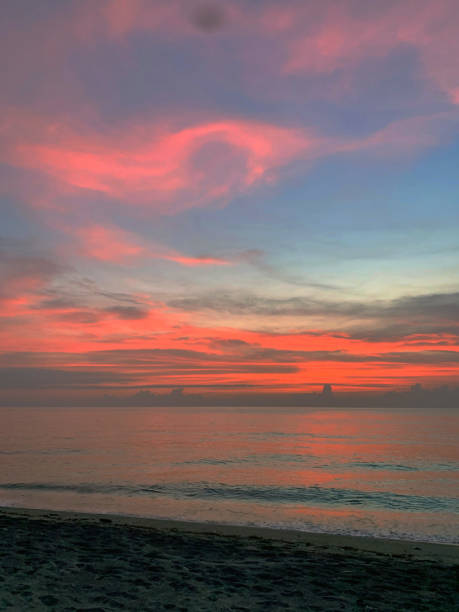 istock Sunset romance with red and blue sky at the beach 2154012815