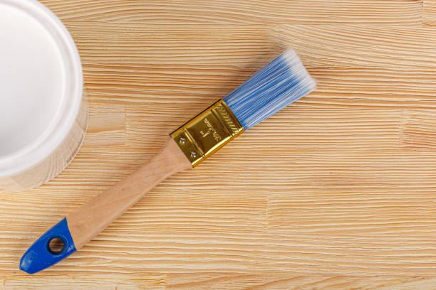 istock white paint with a brush on a wooden background with texture 2154016916