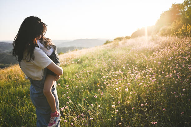 istock Mother embracing daughter outdoors. 2154017426