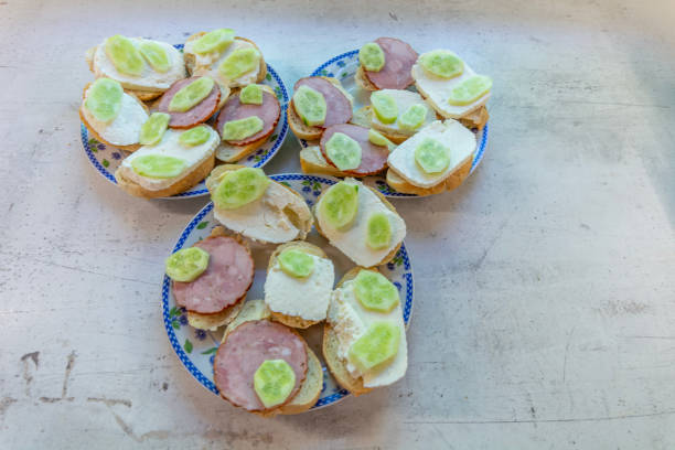 Three plates of sandwiches for a three-person breakfast.