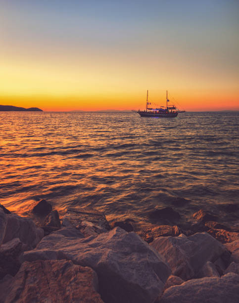 Cruise boat on beautiful sunset on a Greek Island