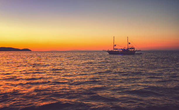 Cruise boat on beautiful sunset on a Greek Island