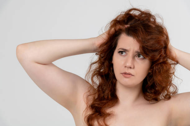 istock Doubting redhead woman portrait against light grey background 2154020583