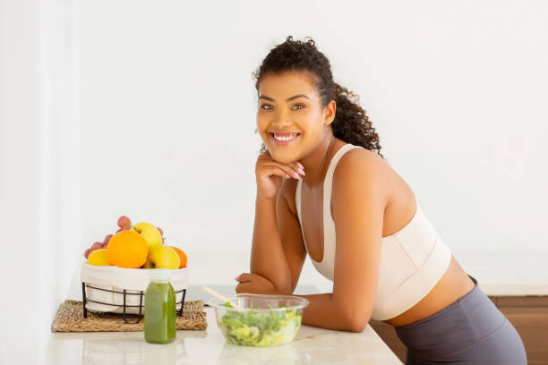 istock Happy slim lady posing near table with nutritious salad indoor 2154027774
