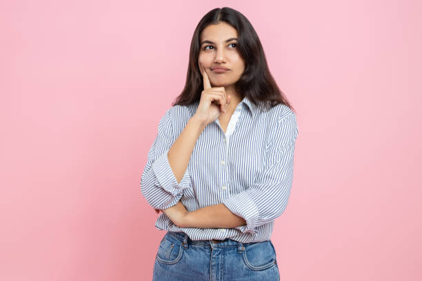 istock Pensive Indian woman holding chin thinking 2154028970