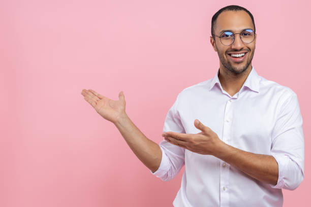 istock Smiling man in white shirt presenting advertisement area 2154028991