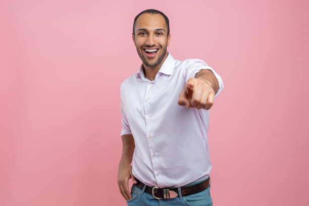 istock Overjoyed man in white shirt pointing finger at camera 2154029014