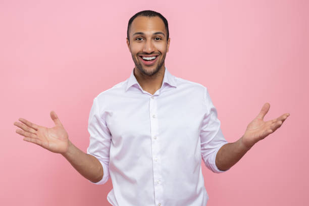 istock Surprised man in white shirt showing welcome gesture 2154029058