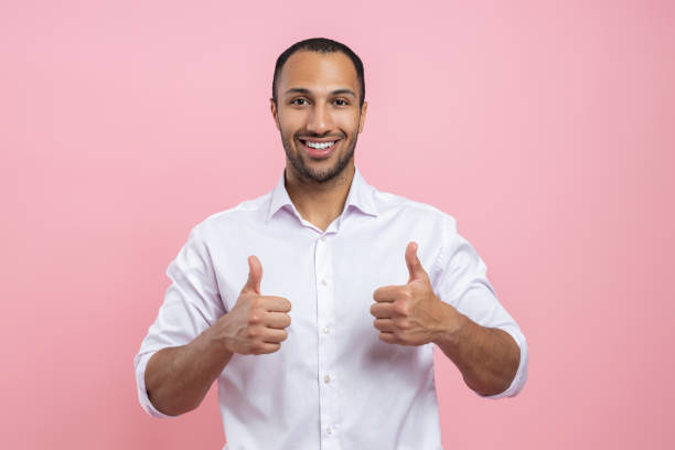 istock Satisfied man in white shirt showing like sign with both hands 2154029060