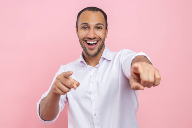istock Excited man in white shirt pointing both fingers to camera 2154029065