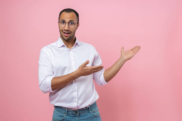 istock Confused man in white shirt presenting advertisement area 2154029082
