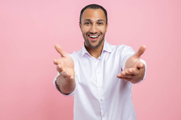 istock Friendly man in white shirt showing welcome gesture 2154029097