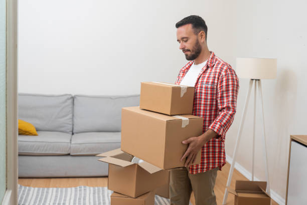 istock Serious male plans to move holding cardboard boxes 2154029640
