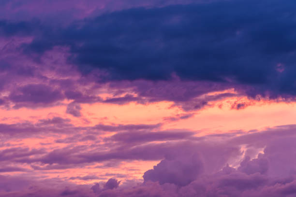 The sky at dusk is painted with hues of purple and pink, creating a stunning sunset. It is a natural landscape with beautiful clouds and an afterglow