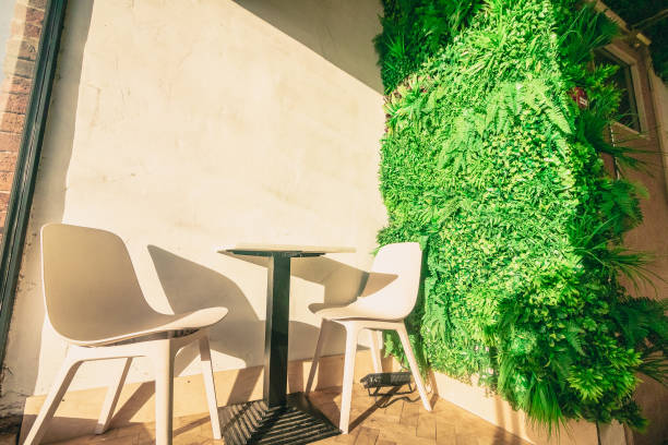 Champagne Glasses on Table Green Napkins Chairs Leaves Plants