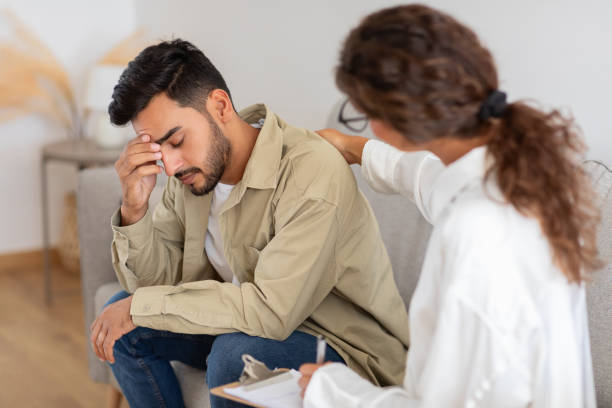 istock Man receiving comfort from therapist in counseling session 2154036203