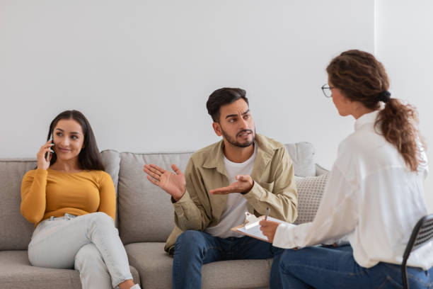 istock Couple distracted by phones during therapy, crisis in relationships 2154036239