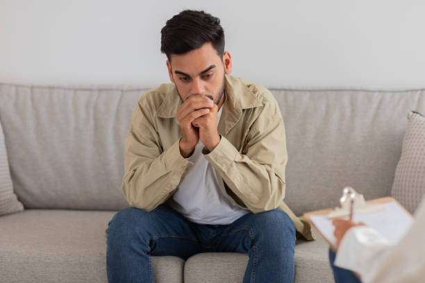 istock Man thoughtful during a counseling with therapist 2154036249