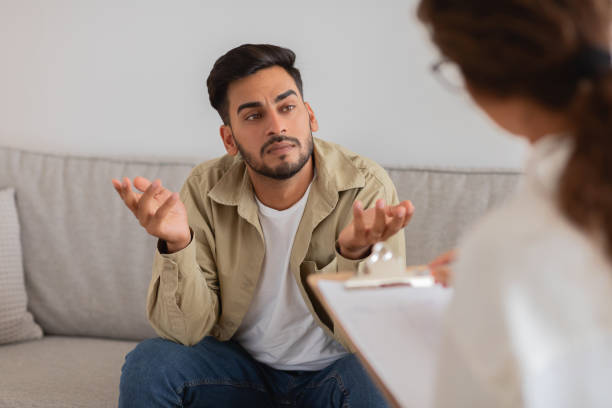 istock Focused man discussing issues in therapy, mental health 2154036251