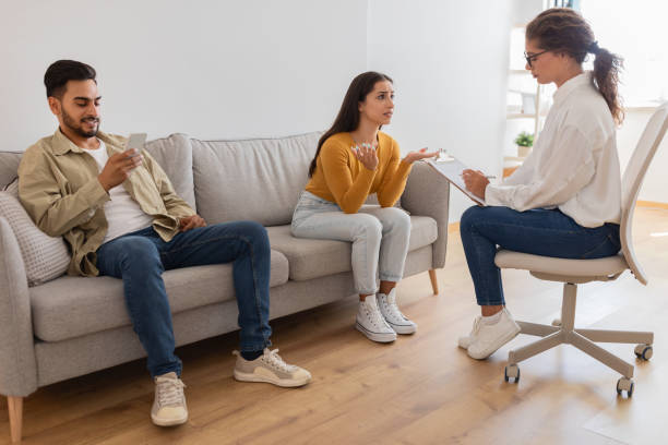 istock Couple in therapy session with counselor, man seems indifferent 2154036266