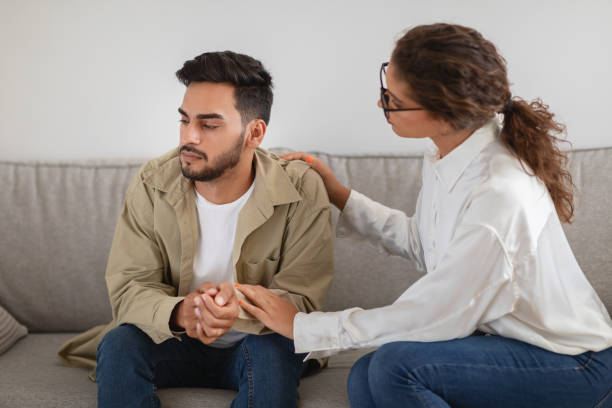 istock Man receiving consolation from a woman therapist 2154036288