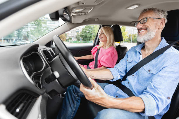 istock Elderly man focused on driving with woman passenger 2154037602